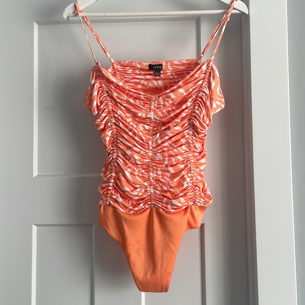 Orange and white bodysuit.  Size L